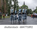 Small photo of Glasgow, Scotland, July 22, 2017. American stilt walkers of the Carpetbag Brigade Physical Theater Company take part in the Merchant City Festival carnival procession.