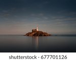 Small photo of Tranquil evening at Mumbles lighthouse A calm full tide evening at Mumbles Lighthouse in Swansea Bay, UK.
