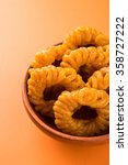 Small photo of Indian sweet jalebi or imarti or imarati, favorite pastry item in Kerala, India. Dewali sweet, fried crispy dessert. yellow, brown, orange jalebis. asian sweet