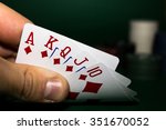 stock-photo-chips-and-cards-for-poker-in-hand-on-green-table-351670052.jpg