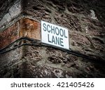 a sign with school lane on the...