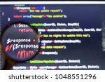 Small photo of PHP back-end code zoomed through a magnifier.