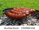 grilling sausages on barbecue...