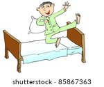 Young boy jumping on the bed - stock photo