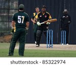 Small photo of PUCHONG, MALAYSIA - SEPT 24: Rakesh Madhavan (batter) of Malaysia reacts after a shot against Guernsey at the Pepsi ICC WCL Div 6 finals at the Kinrara Oval on September 24, 2011 in Puchong, Malaysia.