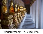 row of golden seated buddhas in ...