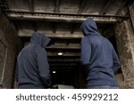 Small photo of criminal activity, addiction, people and social problem concept - close up of addict men or criminals in hoodies on street