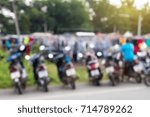 Small photo of The background blurred at the rear of a motorcycle parked in rows in a Thai rural market.