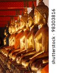 row of sitting buddha statues...