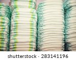 stock-photo-children-s-diapers-stacked-in-a-piles-in-the-child-room-babycare-theme-283141196.jpg