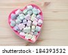 colorful marshmallow in heart shape bowl on table
