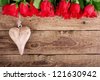 red roses and a heart on wooden board, Valentines Day background,  wedding day - stock photo