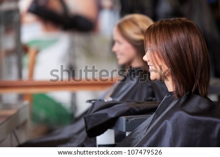 Women sitting in beauty salon.