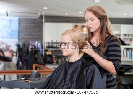 Hairdresser and client in beauty salon.