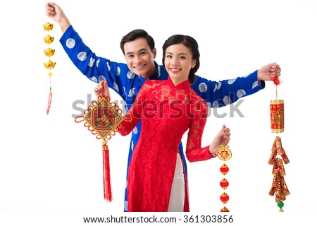 Cheerful Asian couple with various decorations for spring festival