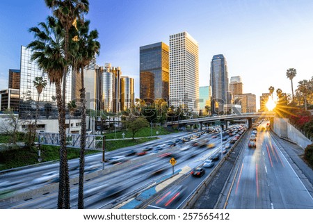 Los Angeles evening sunset highway traffic skyline buildings