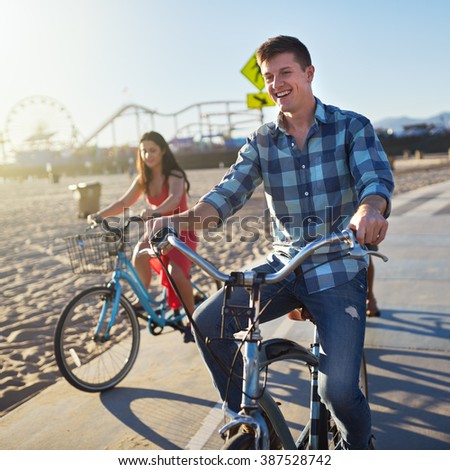 Man With Friends Riding Bikes On Bike Path At Santa Monica Beach Man With Friends Riding Bikes On Bike Path At Santa Monica Beach