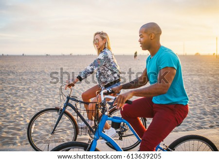 Happy Couple Riding Bikes At Santa Monica Beach Together Happy Couple Riding Bikes At Santa Monica Beach Together
