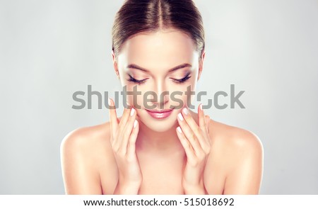 Beautiful Young Woman with Clean Fresh Skin close up . Skin care face . Cosmetology ,beauty and spa . girl washes face .