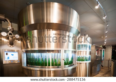 AMSTERDAM, NETHERLANDS - JUN 3, 2015: Bottles of Heineken at the Heineken Experience center, a historic brewery for Heineken beer. Gerard Adriaan Heineken was a founder of the Heineken beer