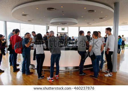 DUBLIN, IRELAND - JULY 12, 2016: Unidentified tourists drink a pint of Guinness at the museum in Dublin. Guinness is an Irish dry stout originated in the brewery of Arthur Guinness