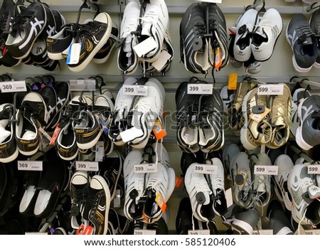 Men's shoes on supermarket's shelves and their price tags with Baht currency Hua Hin, Thailand February 10, 2017