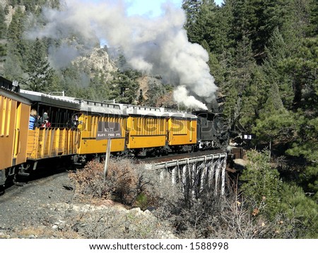 Antique narrow gauge train passing over a trestle at 7200 feet in 