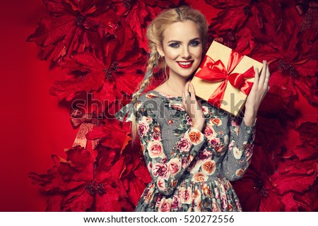 https://thumb9.shutterstock.com/display_pic_with_logo/1125836/520272556/stock-photo-beautiful-young-elegant-woman-in-sexy-red-dress-posing-over-red-background-with-poinsettia-holding-520272556.jpg