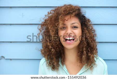 Portrait of a cheerful young african woman smiling