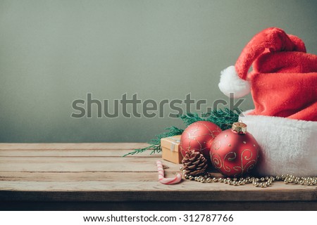 Christmas holiday background with Santa hat and decorations. Retro filter effect