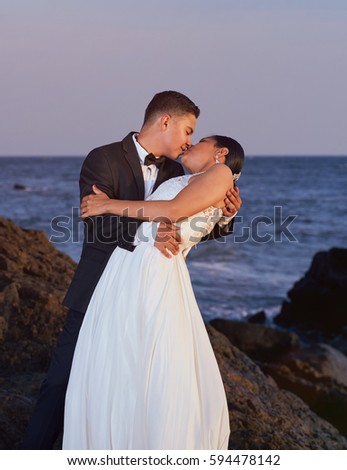 https://thumb9.shutterstock.com/display_pic_with_logo/1154948/594478142/stock-photo-bride-and-groom-kissing-on-beach-sunset-time-wedding-couple-hug-on-ocean-coastline-594478142.jpg