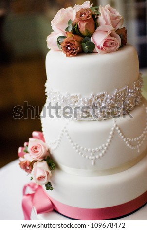 A traditional and decorative wedding cake at wedding reception. - stock photo