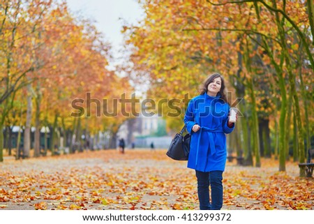 https://thumb9.shutterstock.com/display_pic_with_logo/118180/413299372/stock-photo-beautiful-young-woman-in-paris-on-a-fall-day-with-tea-or-coffee-to-go-413299372.jpg