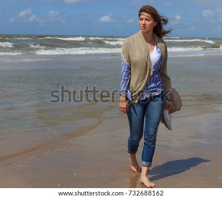 https://thumb9.shutterstock.com/display_pic_with_logo/118423/732688162/stock-photo-young-beautiful-woman-enjoying-the-sea-walking-barefoot-on-sandy-beach-732688162.jpg