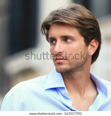 portrait of young handsome man outside