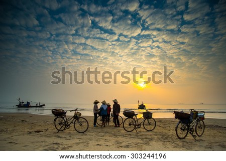 THANH HOA, VIETNAM - DEC 20, 2014: Small fish market on beach in sunrise. Traditional fish market happen only in early morning.