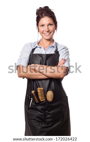 Very attractive and stylish professional hairdresser woman. In professional outfit with tools. Isolated on white.