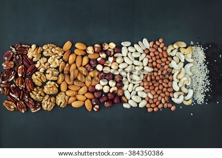 Shape Line Peanut Almond Cashew Walnut Hazel Nut Pecan Sesame Black Wooden Background Top view Healthy Concept