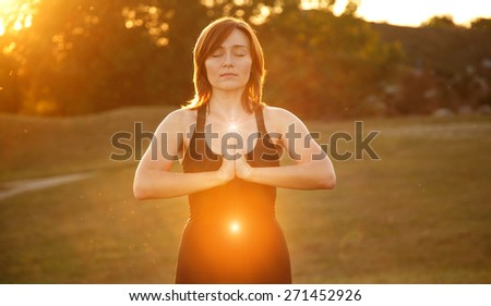 https://thumb9.shutterstock.com/display_pic_with_logo/1286701/271452926/stock-photo-woman-doing-yoga-exercise-at-sunset-modern-young-woman-in-a-city-park-on-a-gym-or-yoga-the-glow-271452926.jpg