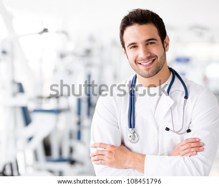 Friendly male doctor at the gym smiling