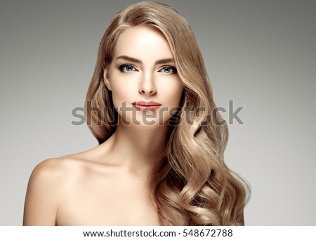 Amazing woman portrait. Beautiful girl with long wavy hair. Blonde model with hairstyle
