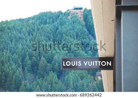 Queenstown, New Zealand-June 10, 2017: Sign of Louis Vuitton with hill background