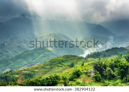Amazing view of rays of sunlight through storm clouds in the Hoang Lien Mountains of Sapa District, Lao Cai Province, Vietnam. Sa Pa is a popular tourist destination of Asia.