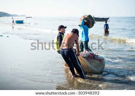 Long Hai, Ba Ria - Vung Tau, Vietnam - 31 May 2015: Fishermen carrying net back home from a long trip at Long Hai, Ba Ria - Vung Tau, Vietnam