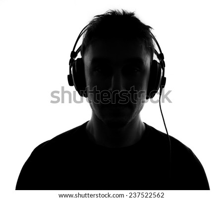 Male silhouette with headphones.Isolated on white background - stock photo