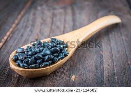 Black beans on wooden background - vintage effect style pictures