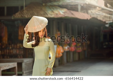 Beautiful woman with Vietnam culture traditional dress,Ao dai is famous traditional costume ,vintage style,Vietnam