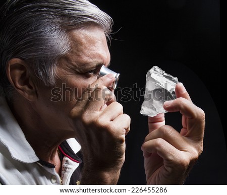portrait of a jeweler during the evaluation of jewels
