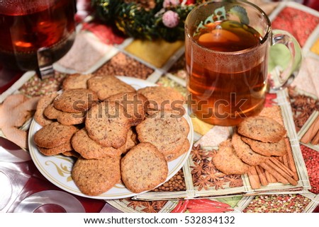 ginger biscuits with tea and jar of jam on a New Year's background