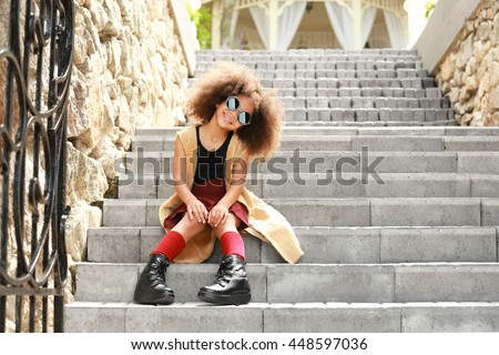 Afro American little girl wearing stylish clothes outdoors. Fashion kid concept